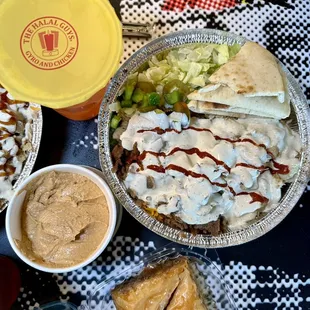 Combo platter with white sauce and hot sauce. Chipotle hummus and baklava.