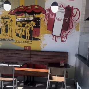 a restaurant with a mural on the wall