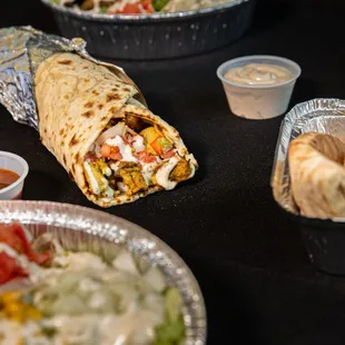 a burrito, salad and fries