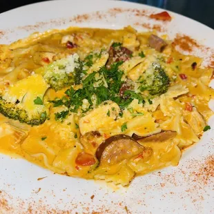 a plate of pasta with broccoli and cheese