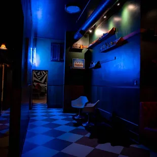 Walkway to the back room and food also where the restroom is located.