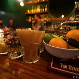 a bowl of noodles, oranges, and limes