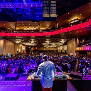 a dj performing in front of a large audience