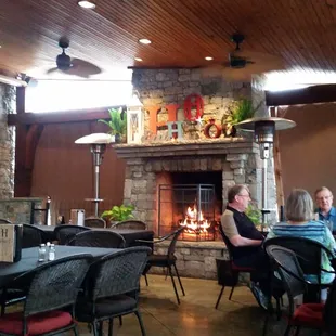 Lovely enclosed patio! Fire is blazing in the fireplace because it's a bit breezy and chilly in Tulsa this afternoon.