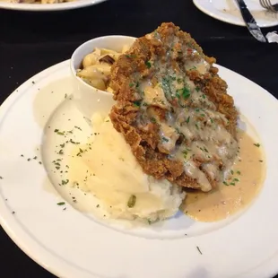 Chicken fried steak with mashed potatoes and Mac and cheese