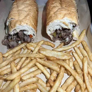 two sandwiches and french fries on a tray