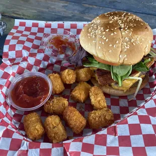a burger and tater tots on a table