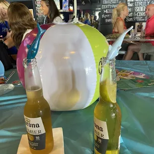two bottles of corona beer and a beach ball