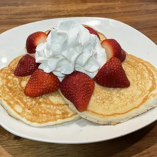 Strawberry Pancakes: Three Fluffy Buttermilk Pancakes, topped with Fresh Strawberries and whipped cream.