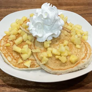 Hawaiian Pineapple Pancakes. Three Fluffy Buttermilk Pancakes, topped with freshly cut Hawaiian Pineapple and whipped cream.