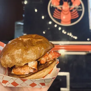 a hand holding a sandwich