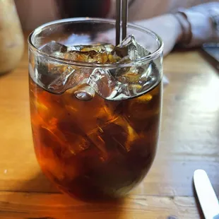 a glass of iced tea on a table