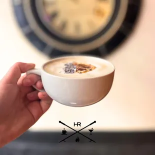 a hand holding a cup of coffee