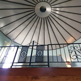 Looking up at the ceiling and queen bed loft from the entry
