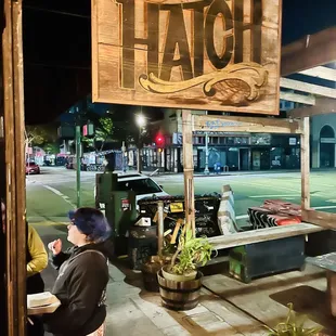 Sign in front of the entrance to the bar and kitchen.