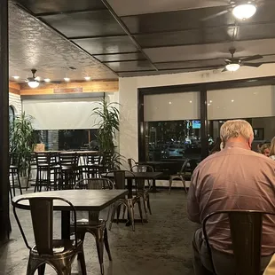 people sitting at tables in a restaurant