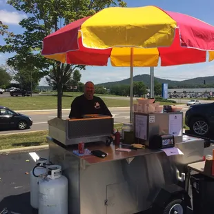 a man sitting under an umbrella