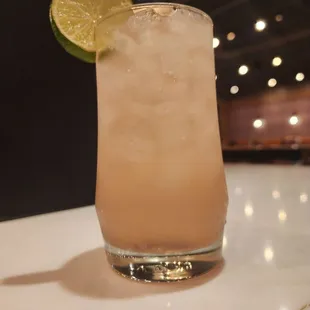 a cocktail with a lime slice