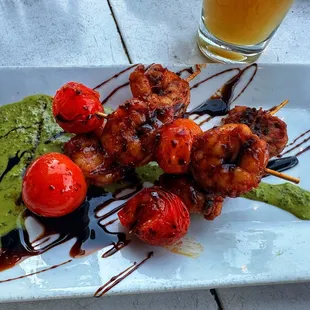 a plate of skewered food