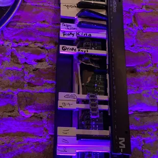 a rack of electronic equipment against a brick wall