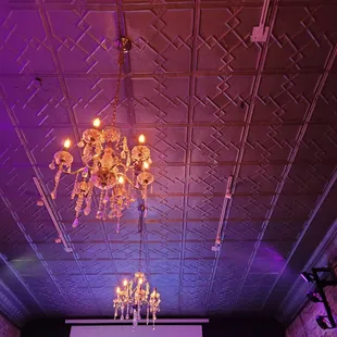a large screen and a chandelier