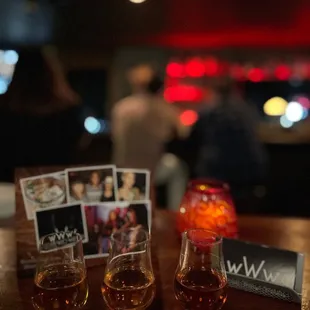 three glasses of whiskey on a table