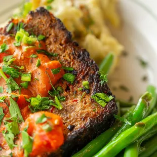 Meatloaf - all-beef meatloaf. stewed tomato gravy. mashed potatoes. green beans.