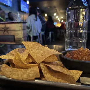 a tray of chips and salsa