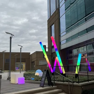 a colorful sculpture in front of a building