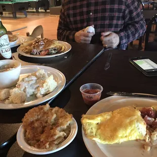 a man sitting at a table with plates of food