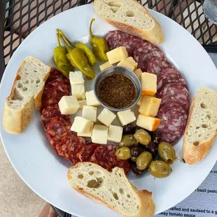 a plate of meat and cheese with bread