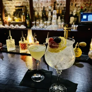 two cocktails on a bar