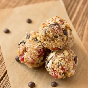 three chocolate chip cookies on a piece of brown paper