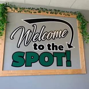 a welcome to the spot sign