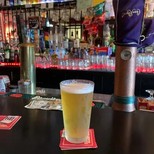 a glass of beer on a bar