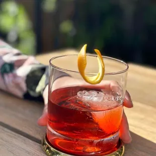 Enjoy a Negroni cocktail next to our creekside firepit