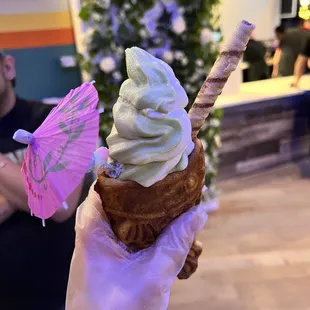 an ice cream cone with a pink umbrella