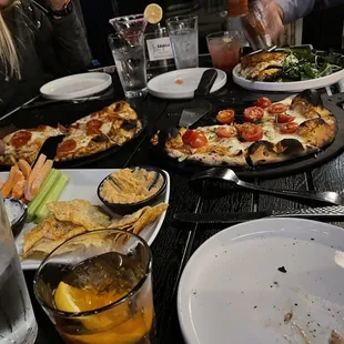 a group of people eating pizza at a restaurant