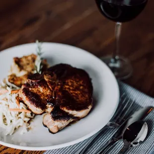 a plate of food and a glass of wine