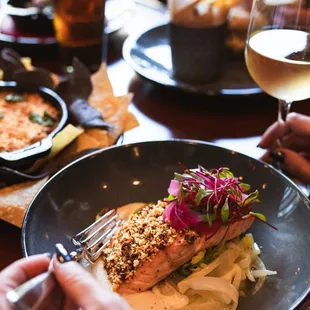 a plate of food and a glass of wine