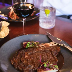 a steak and a glass of wine