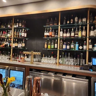 a bar with many bottles of alcohol