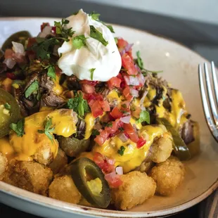 Tater Tot Nachos (braised short rib, jalapeno, cheese sauce, pico de gallo, sour cream)