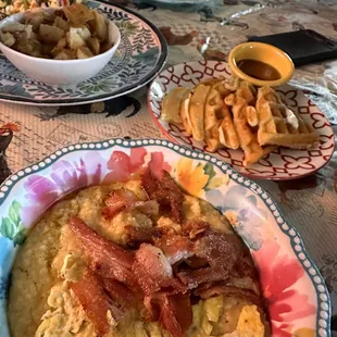 Mmmm some comfort food this am. Cheese grits with scrambled egg and bacon on top. Waffles tastes homey