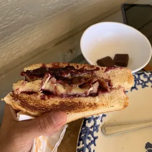 Grilled Brie sandwich with blackberry preserves, thick cut bacon and a fried egg white  I inhaled it, barely stopped to take a photo