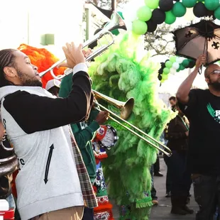 a man playing a trombone in a parade