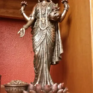 a statue of a woman holding a pot