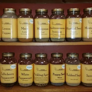 a shelf full of jars of herbs