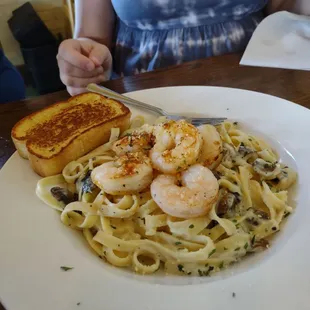 a plate of pasta with shrimp
