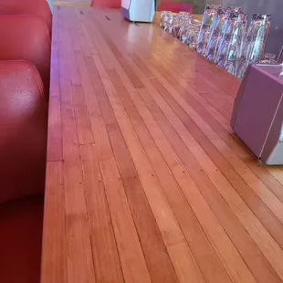 a long wooden table with red chairs